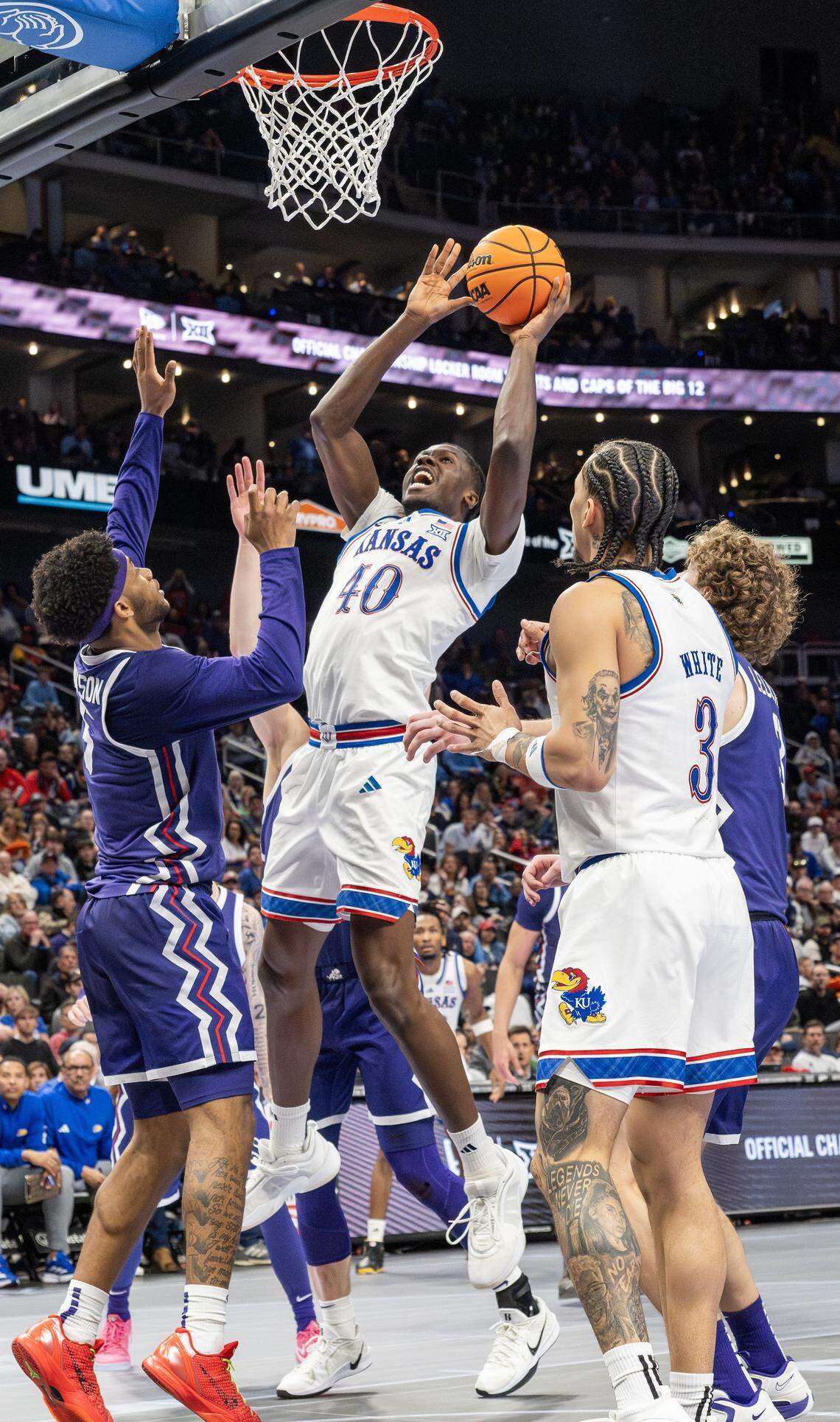 Kansas Jayhawks forward Flory Bidunga (40) makes a layup during the second half of a Big 12 Men's Basketball Tournament game against the Texas Christian University Horned Frogs at T-Mobile Center on Thursday, March 12, 2026, in Kansas City.