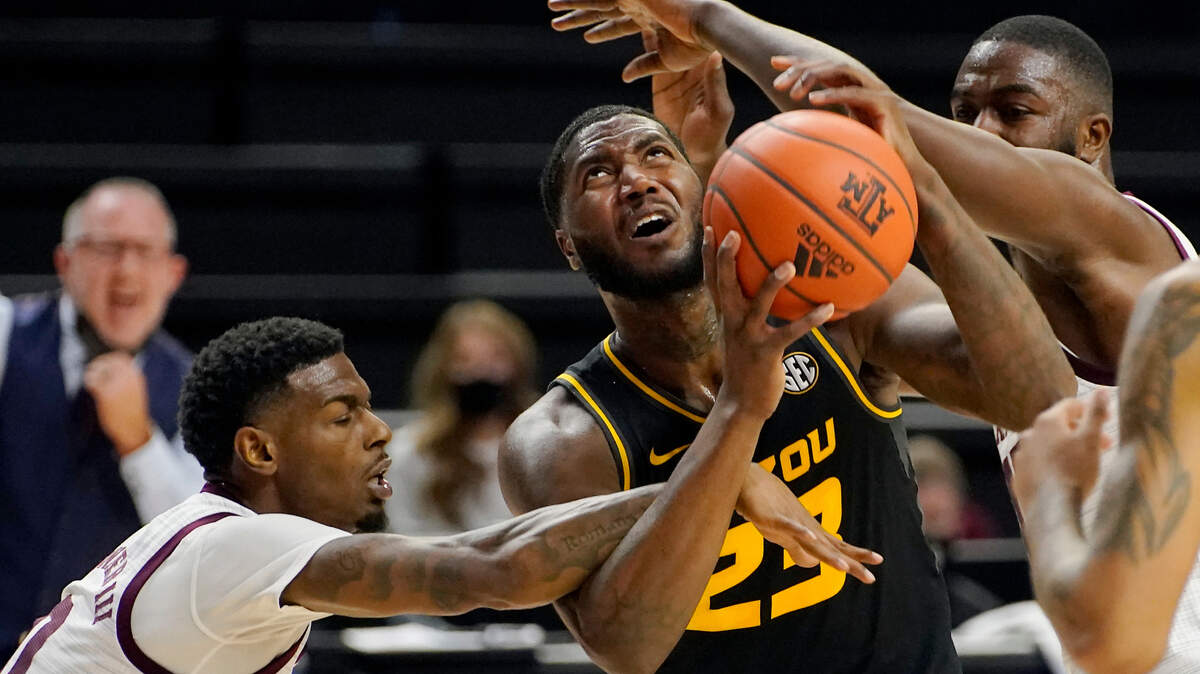 Missouri forward Jeremiah Tilmon (23) is fouled by Texas A&M guard Jay Jay Chandler (0) trying to shoot a basket during the first half of an NCAA college basketball game Saturday, Jan. 16, 2021, in College Station, Texas. (AP Photo/Sam Craft)