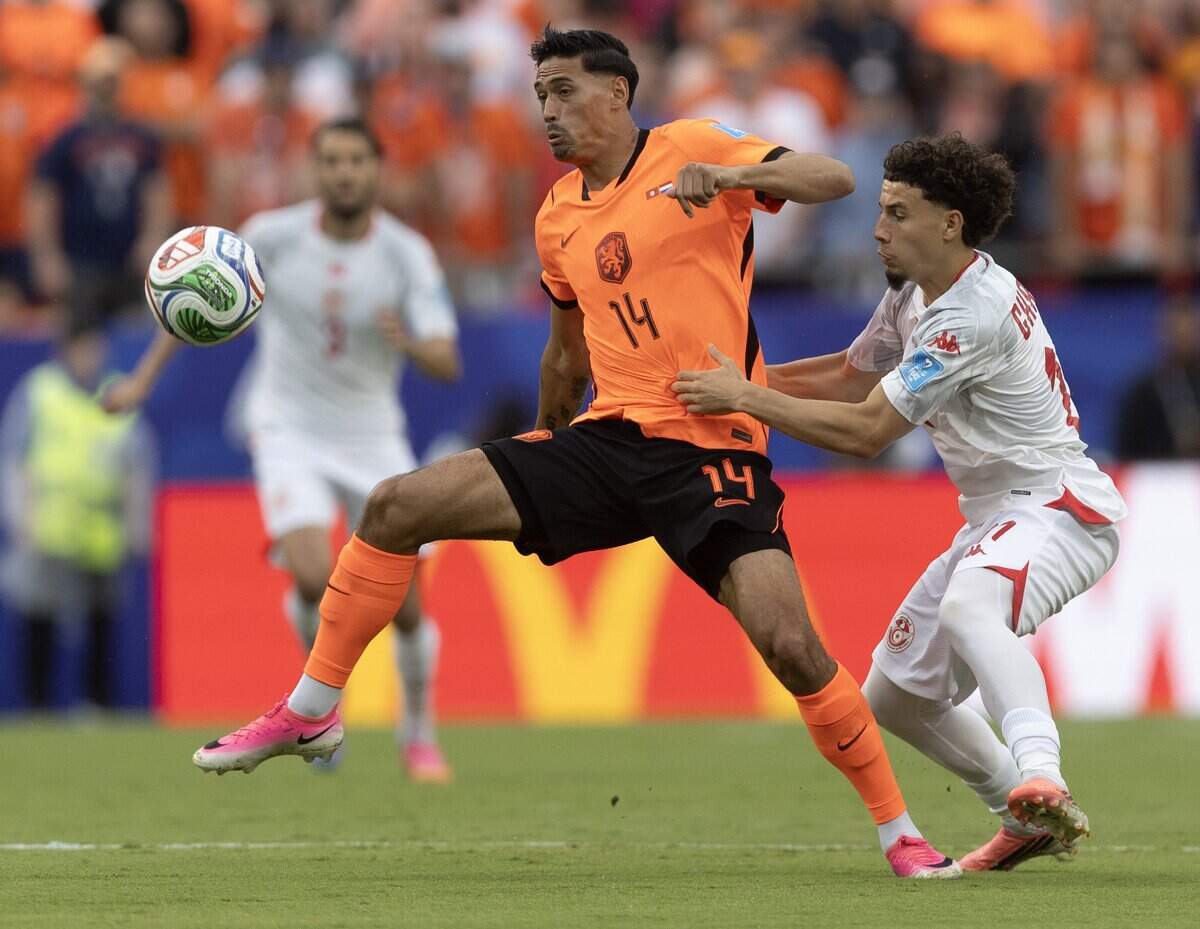 Netherlands midfielder Tijjani Reijnders (14) keeps the ball away from Tunisia midfielder Ismaël Gharbi (11) during a FIFA World Cup group-stage soccer match at Kansas City (Arrowhead) Stadium in Kansas City on Thursday, June 25, 2026.
