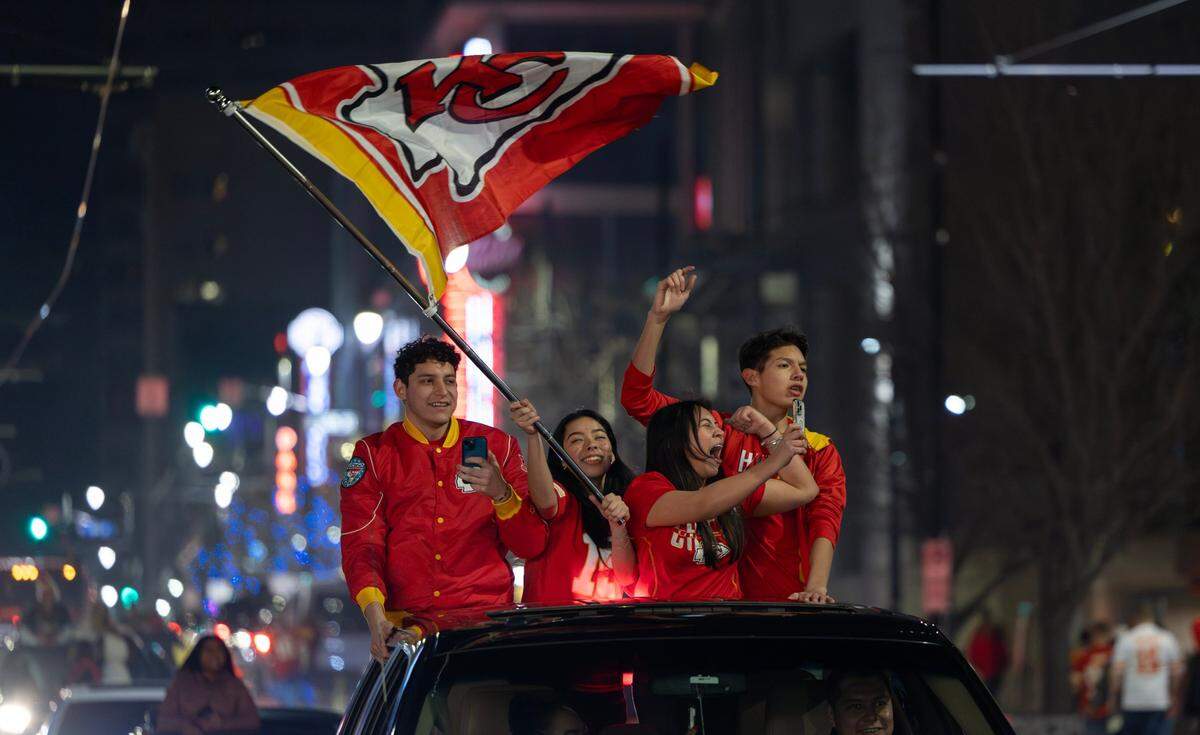 Kansas City Chiefs fans celebrate on Main Street after Chiefs won the Super Bowl in overtime on Sunday.