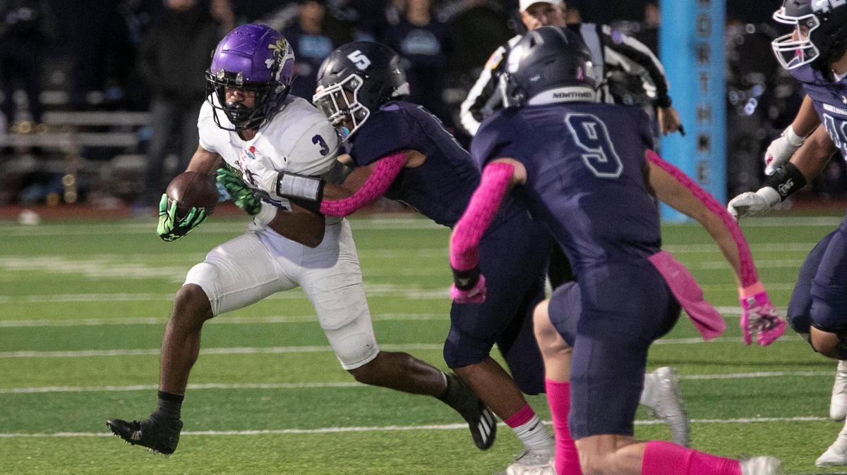 The Oak Park defense closes in on North Kansas City’s Mahki Staten (No. 3) during their high school football game on Friday night.
