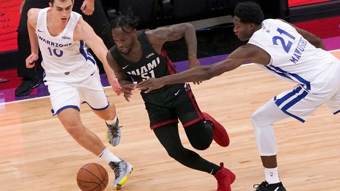 Miami Heat guard Marcus Garrett, center, drives between Golden State Warriors’ Justinian Jessup, left and Selom Mawugbe during the first half of a California Classic NBA summer league basketball game in Sacramento, Calif., Wednesday, Aug. 4, 2021. (AP Photo/Rich Pedroncelli)
