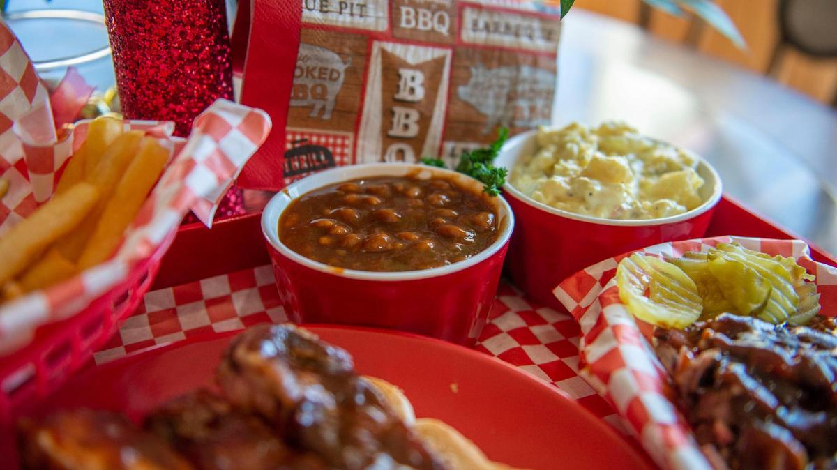 House-made baked beans and potato salad are sides on the menu at P Moore & Moore BBQ.
