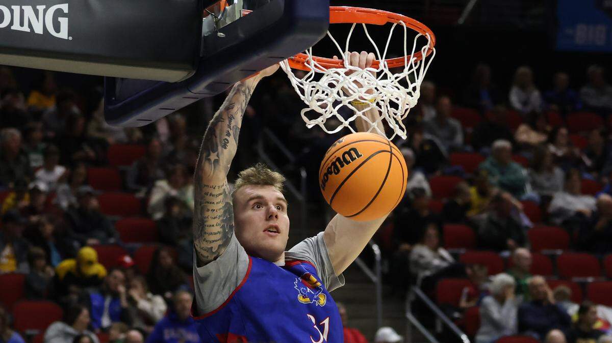 Kansas Jayhawks forward Cam Martin (31) dunks during a practice session at Wells Fargo Arena in Des Moines, Iowa, on March 15, 2023.
