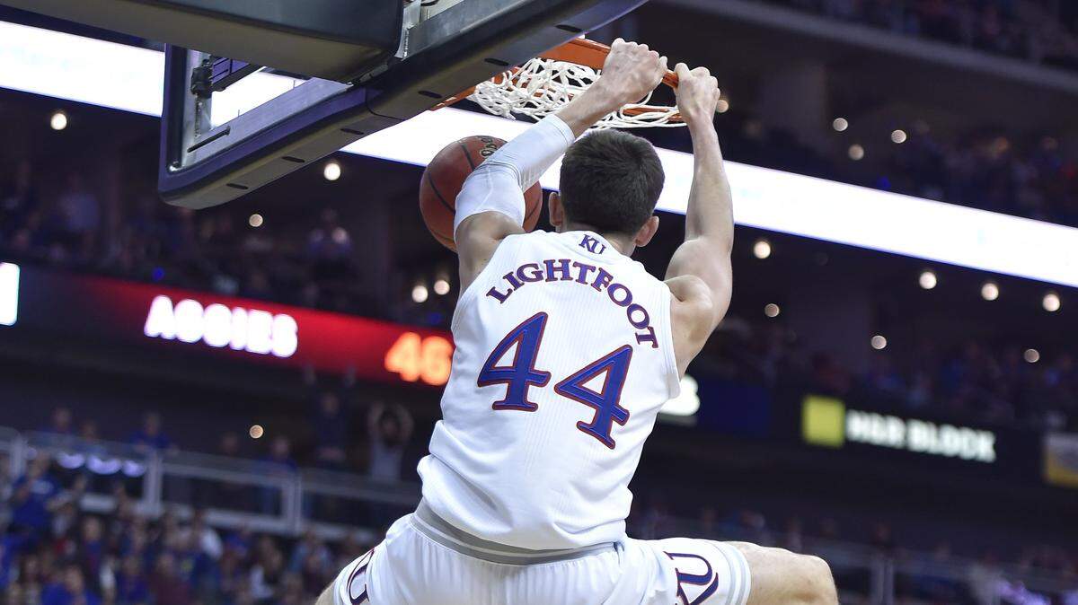 KU’s Mitch Lightfoot threw down a dunk against New Mexico State during the second half on Saturday at the Sprint Center.