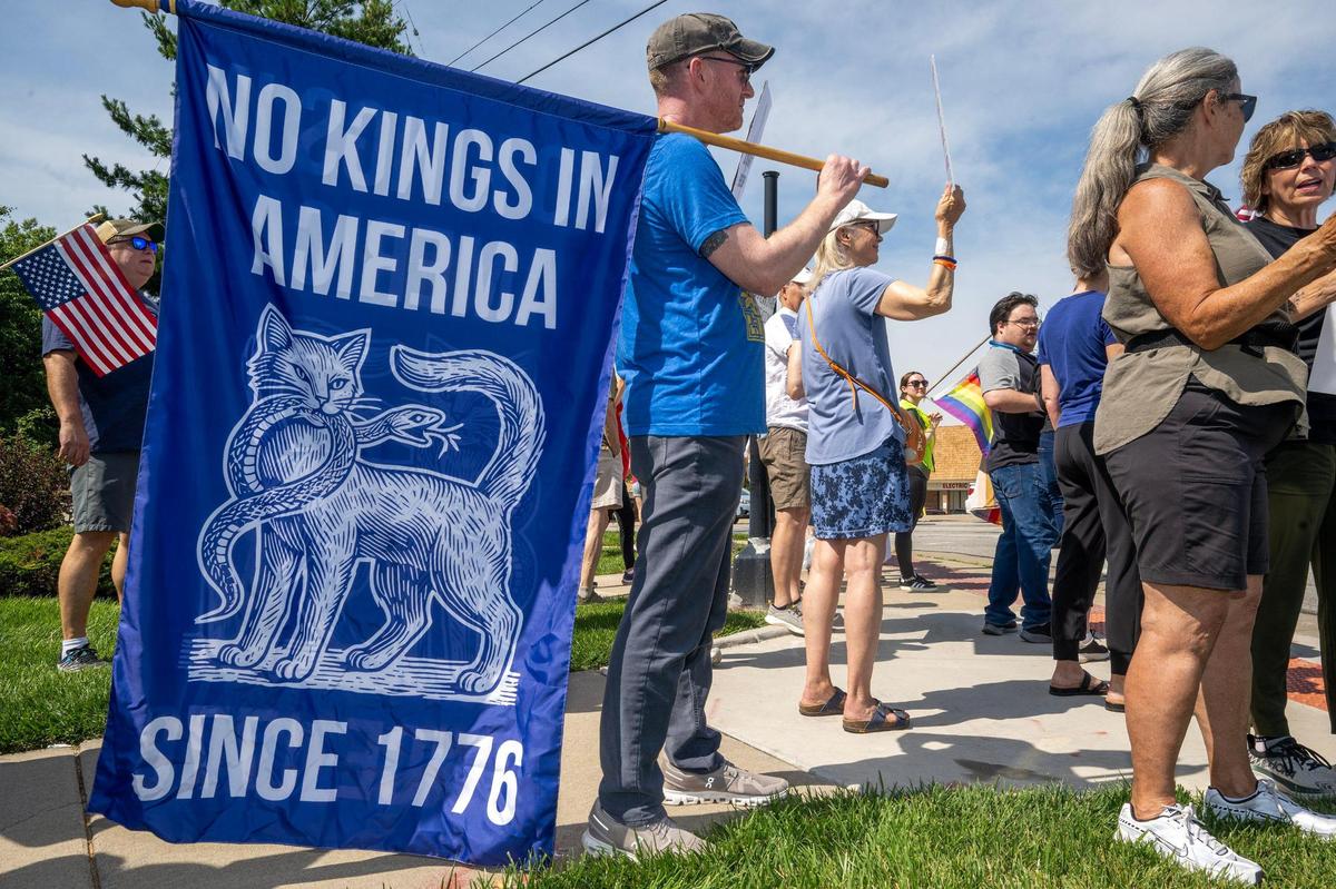 A protester carried an oversized “No Kings in America” flag during a nationwide “No Kings” day of defiance on Saturday, June 14, 2025, in Lenexa, Kansas. The events protest President Donald Trump and immigration policies, among other issues.