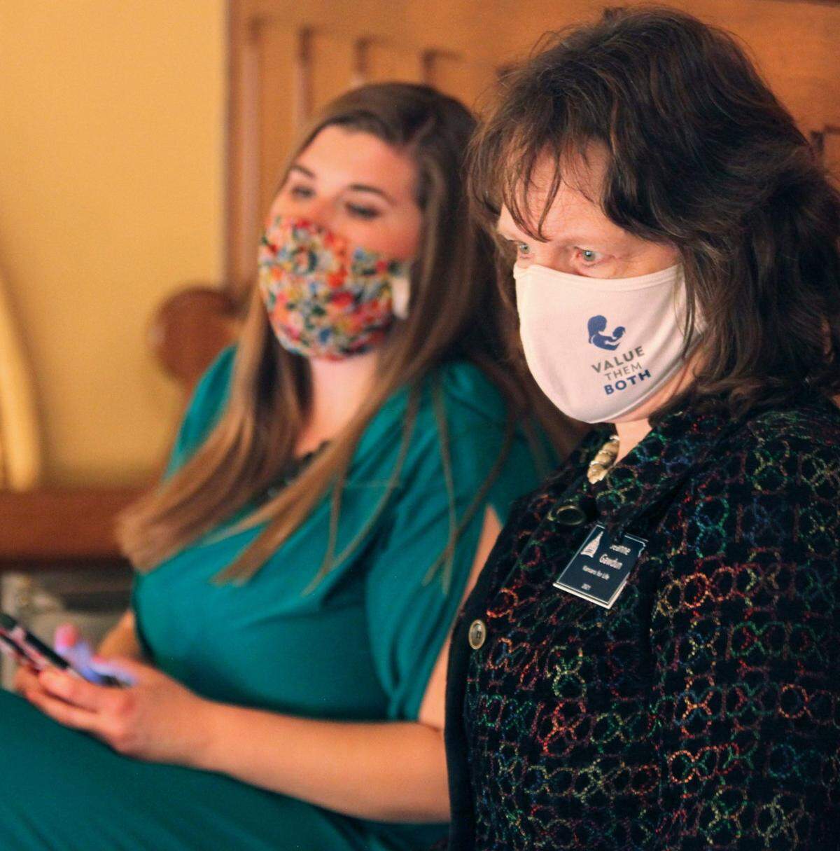 In this photo from Thursday, April 8, 2021, Jeanne Gawdun, right, a lobbyist for Kansans for Life, the most influential anti-abortion group in Kansas politics, watches a state Senate debate from one of its galleries at the Statehouse in Topeka, Kan. She sees an increase in abortions in Kansas in 2020 resulting from Democratic Gov. Laura Kelly’s refusal to ban elective abortions temporarily during the early weeks of the coronavirus pandemic when Republican governors in Oklahoma and Texas did. (AP Photo/John Hanna)