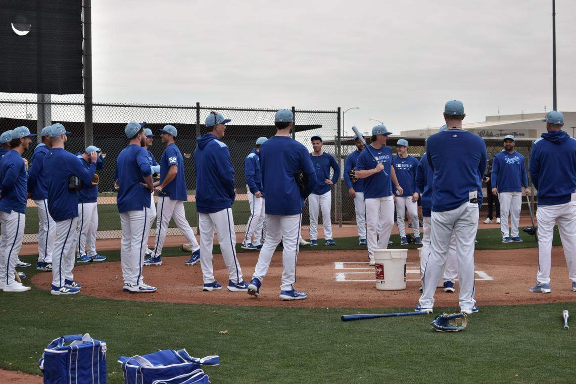 Kansas City Royals pitchers gather around home plate during their first workout session at the club’s spring training complex in Surprise, Arizona on Wednesday, Feb. 12, 2025.