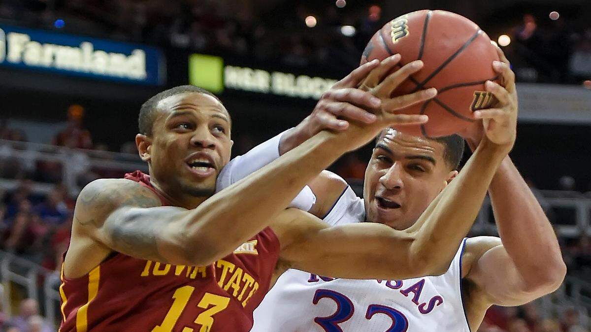 Iowa State Cyclones guard Bryce Dejean-Jones (13) and Kansas Jayhawks forward Landen Lucas (33) battle for a rebound early in game action Saturday evening, March 14, 2015 at the Big 12 Men's Basketball Championship Tournament at Sprint Center in Kansas City, Mo.