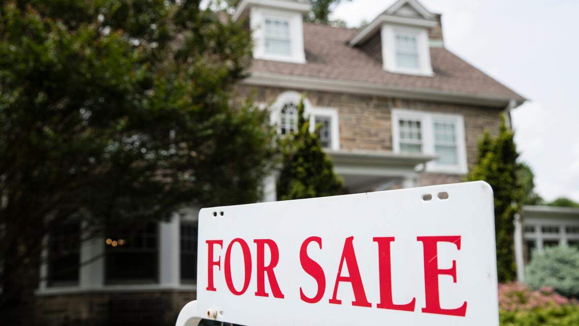 File photo of a home with a “for sale” sign. A Missouri woman won a $2 million lottery prize with a ticket she bought before heading home from a house hunting trip.