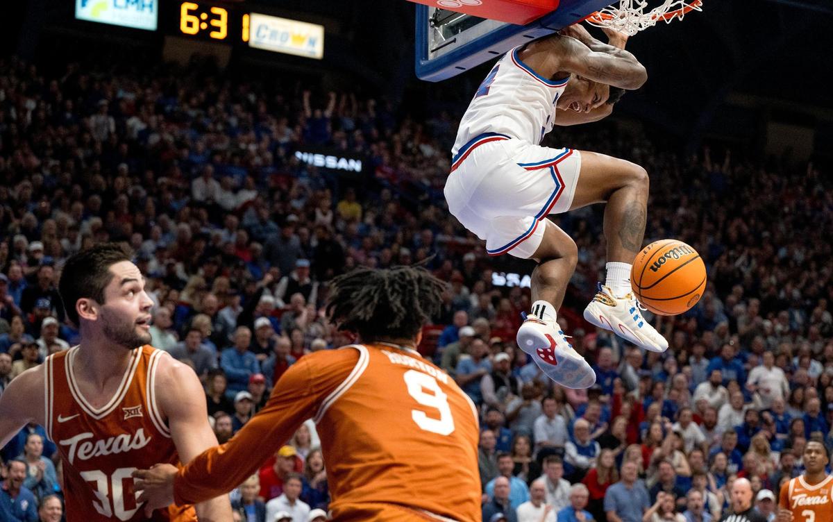 Kansas Jayhawks forward K.J. Adams (24) dunks the ball over Texas Longhorns guard Ithiel Horton (9) and forward Brock Cunningham (30) during an NCAA college basketball game on Saturday, Feb. 24, 2024, in Lawrence.