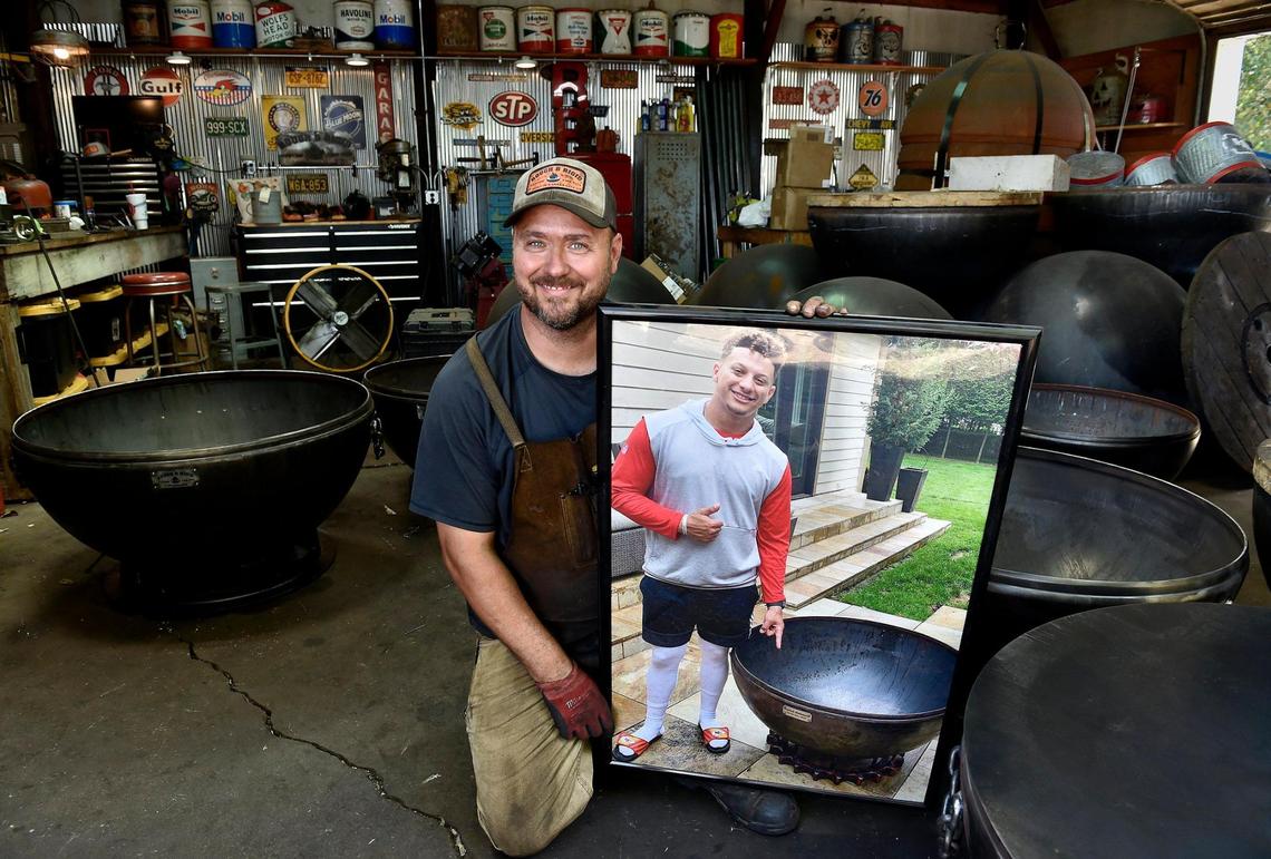 Brad Easley holds a photo of his most famous customer to date. In exchange for his fire pit with a custom tractor sprocket as the base, Chiefs quarterback Patrick Mahomes allowed Easley to use this photo in his ads.