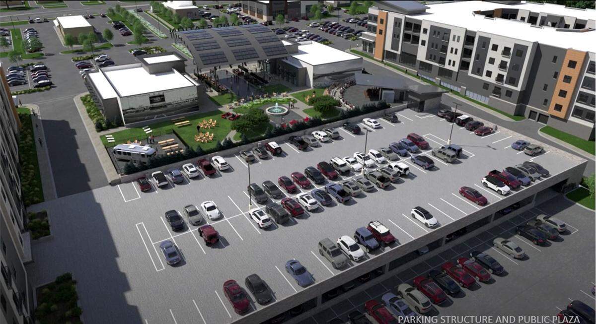 The parking structure will be located behind two restaurants. An outdoor space will connect the two restaurants in between the two apartment buildings.