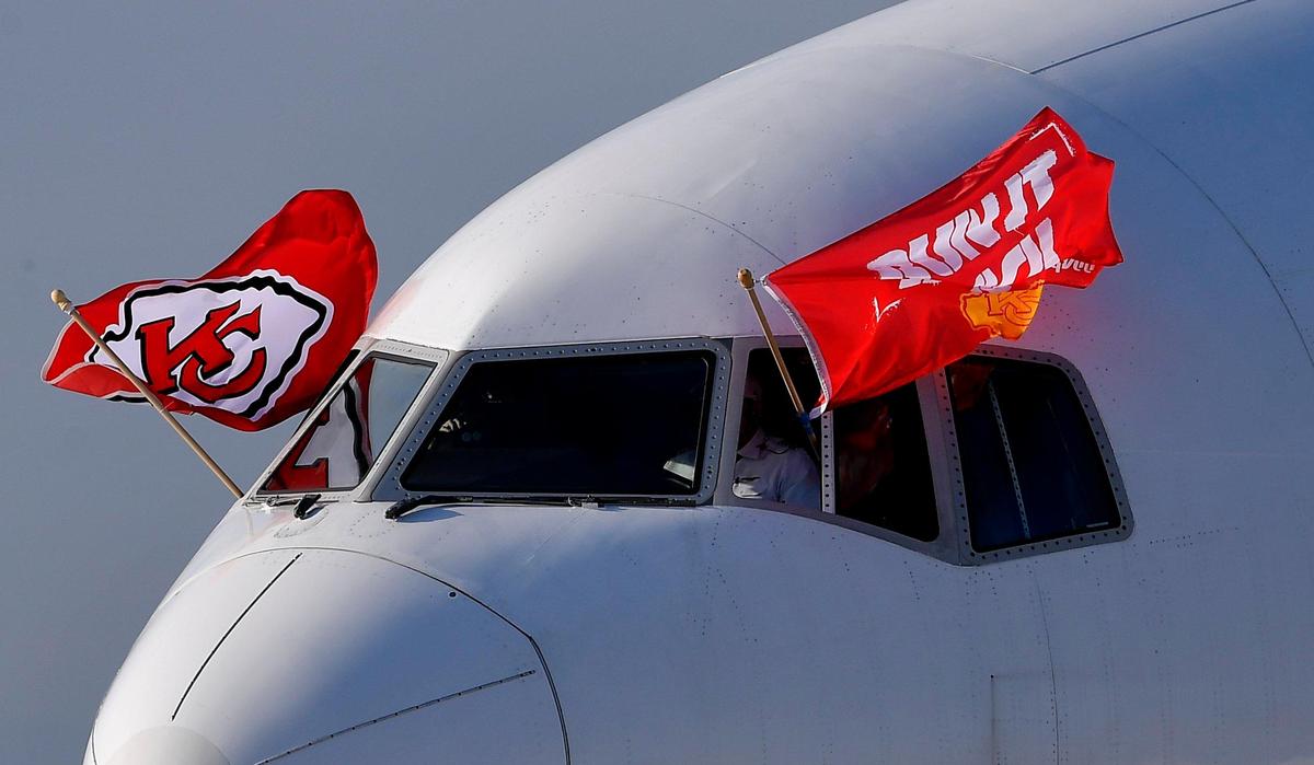 With the Chiefs flags waving in a stiff breeze, the team plane arrives Saturday evening in Tampa, where they will take on the Buccaneers Sunday in Super Bowl LV.