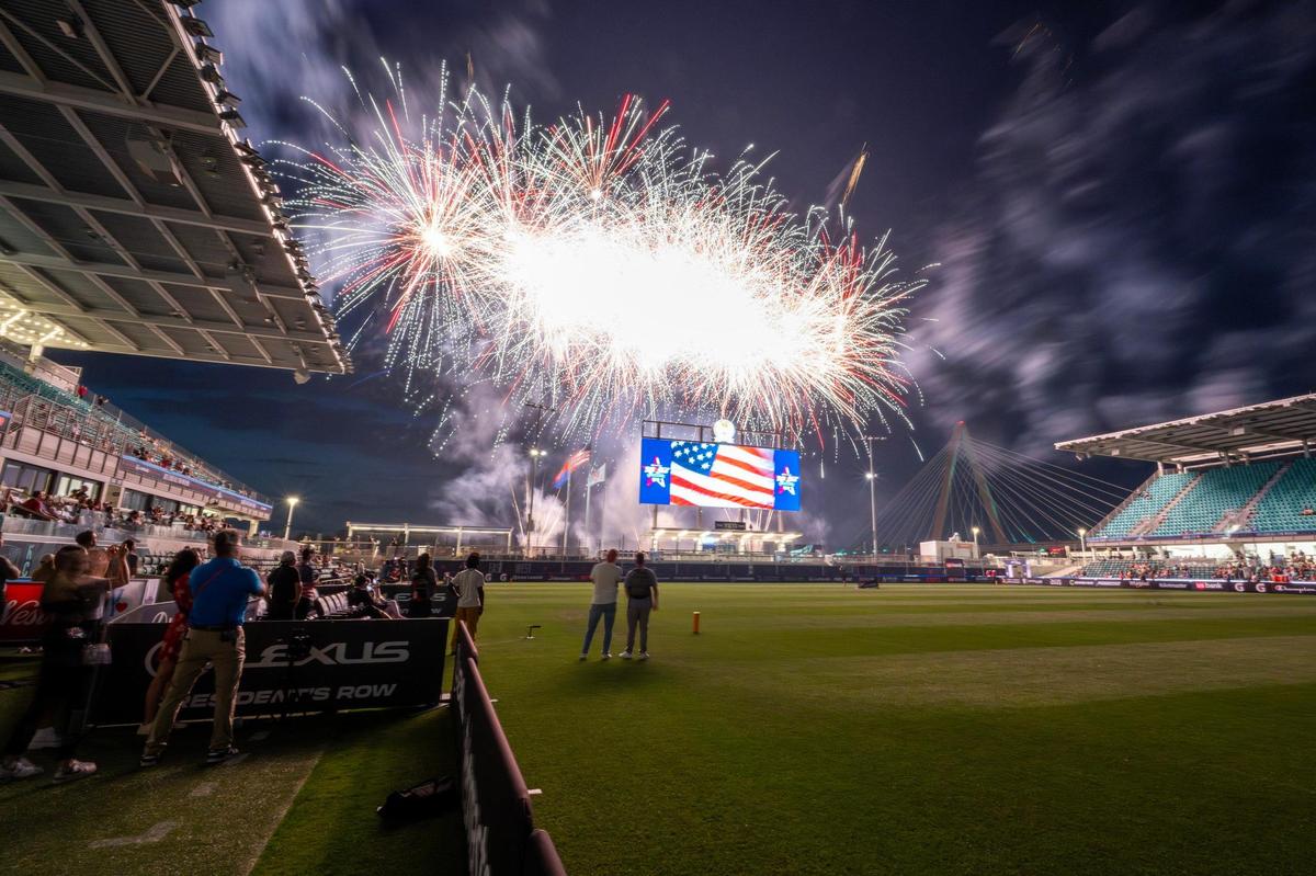Fireworks from a Fourth of July show burst above CPKC Stadium, seen from behind the scoreboard looking toward the Missouri River, following the Maybelline Women’s Lacrosse League All-Star Game on Friday, July 4, 2025, in Kansas City.