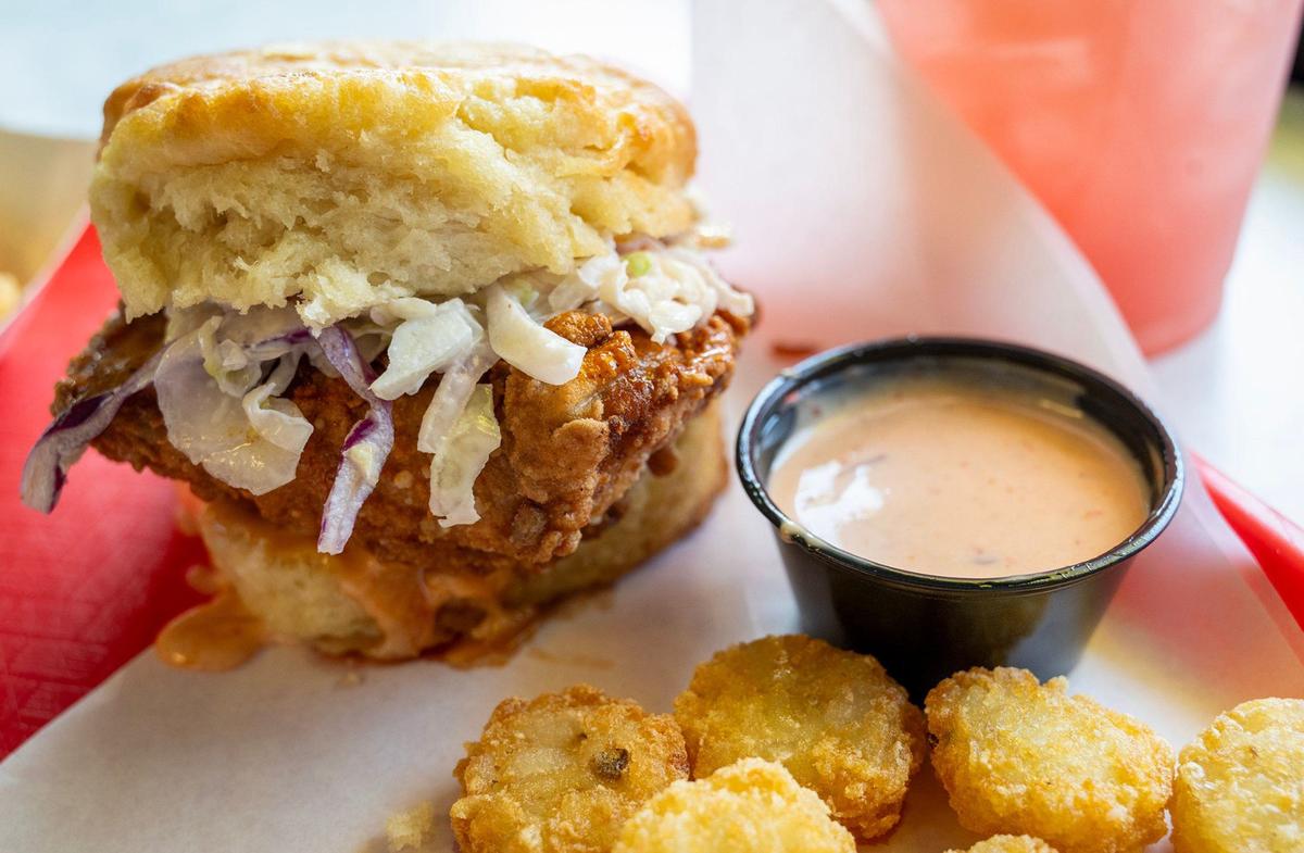 The Charlie Hustle, a biscuit sandwich from District Biskuits, which opened in 2022 in North Kansas City. The sandwich features Nashville hot fried chicken, hot honey sauce, creamy coleslaw, dill pickles, DB sauce.