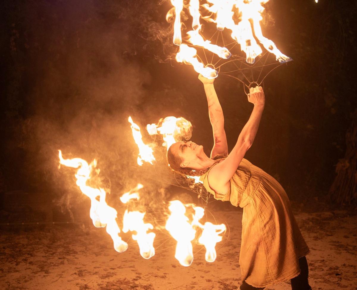 A fire dancer performs at Exiled KC-Crooked Rose Woods.