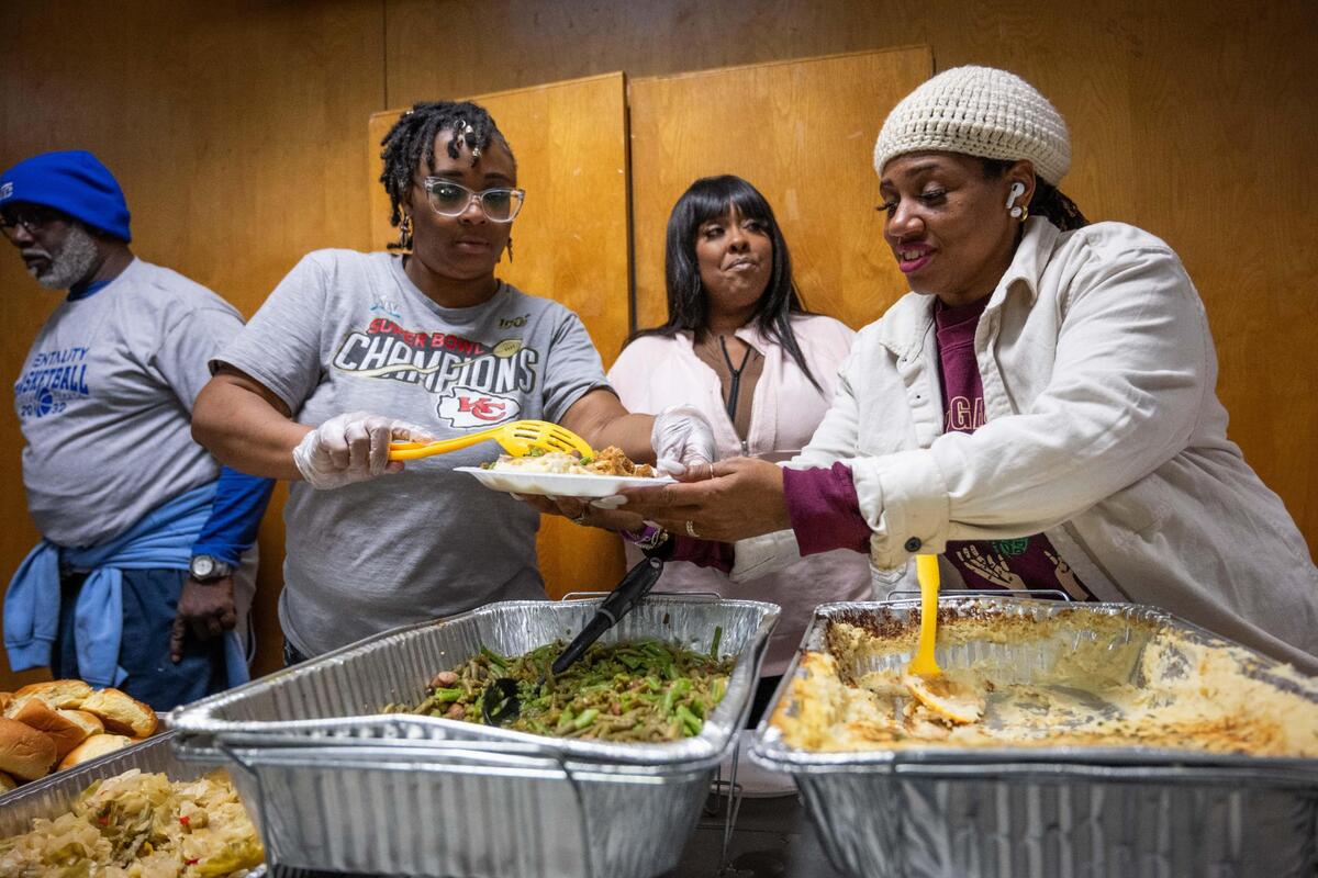 Organizers and volunteers serve meals at the Gregg Klice Community Center in Kansas City on Giving Tuesday.