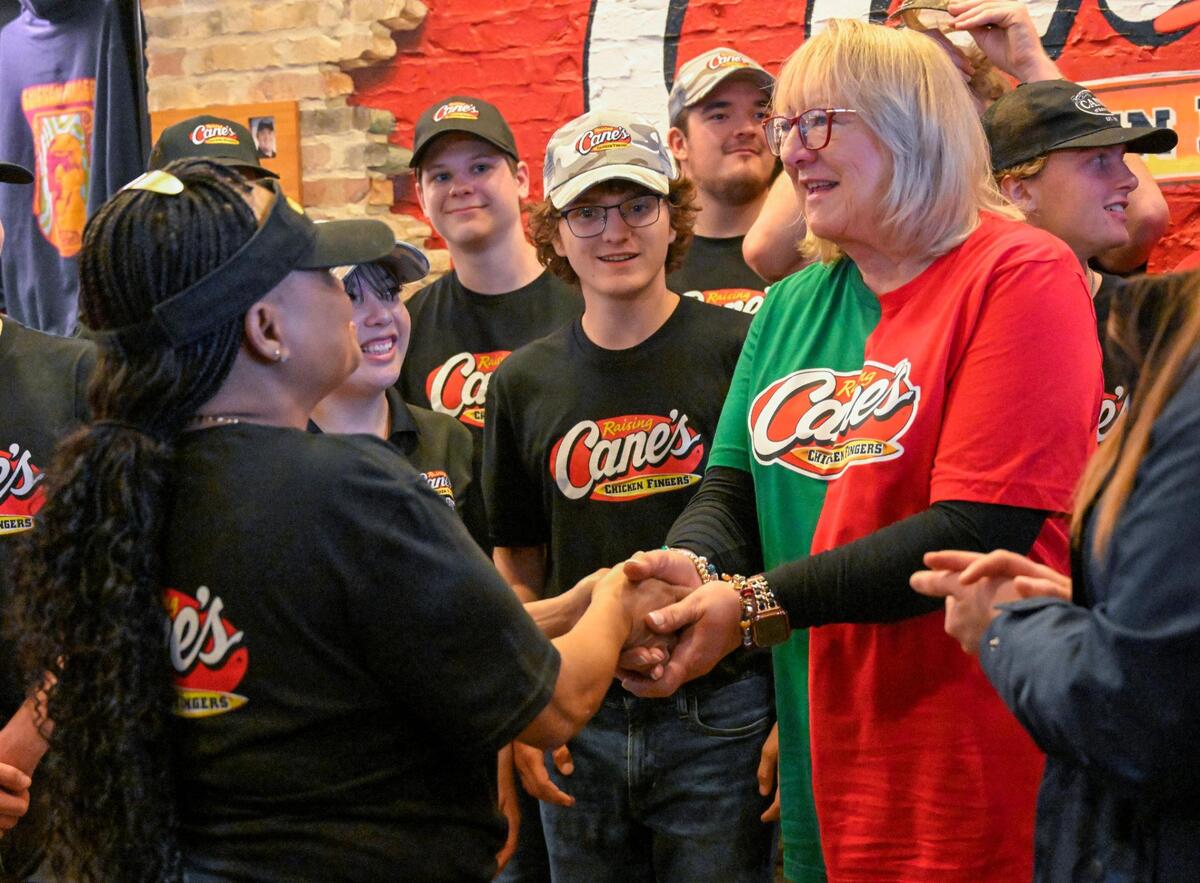 Donna Kelce greeted employees during a pre-game stop at Raising Cane’s on Monday in Overland Park.