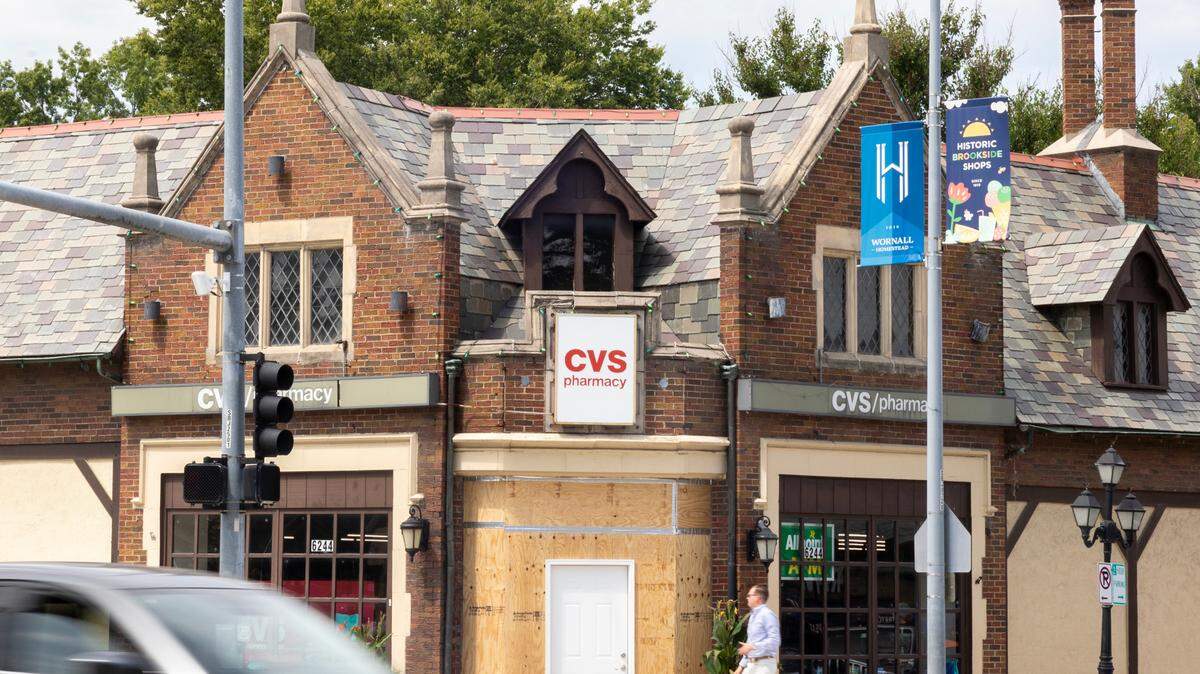 A customer heads for a makeshift door at the CVS location at West 63rd Street and Brookside Boulevard in Kansas City. The doorway was put in place after the front of the business was damaged in an apparent break-in on the morning of Friday, Aug. 23.