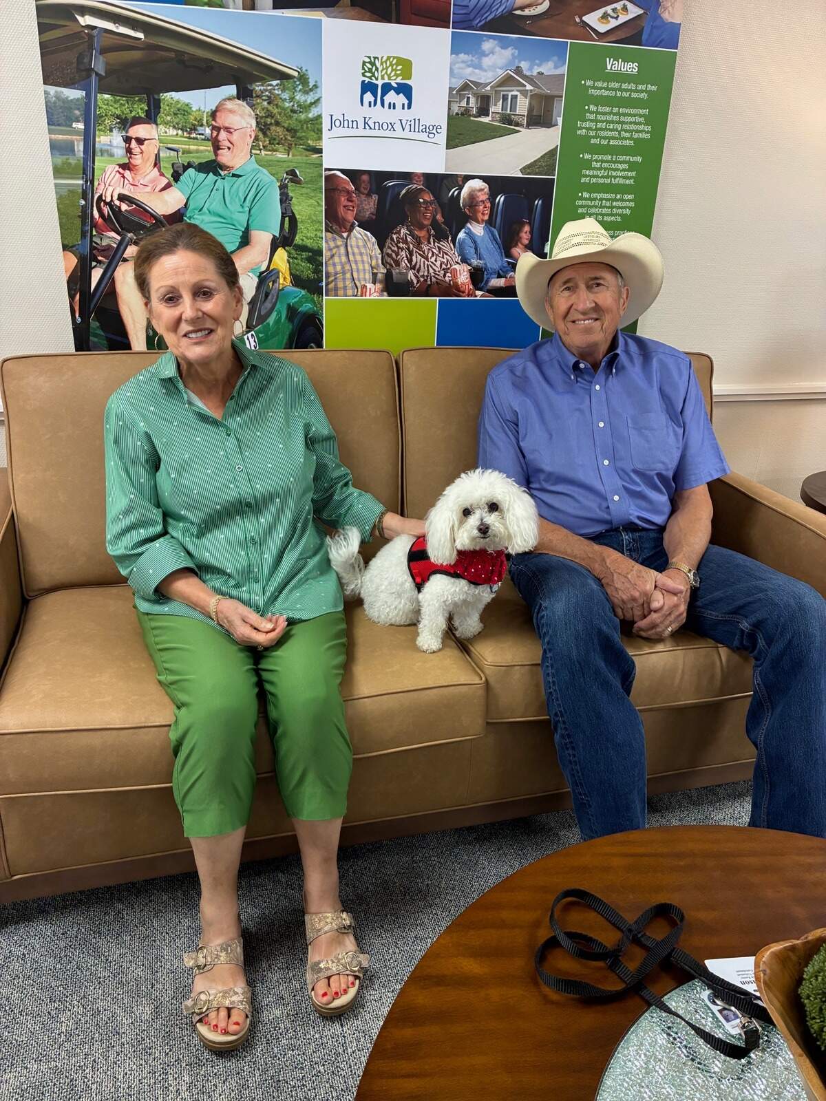Michael and Allyson Kenny pose with Samson, an 11 ½-year-old Bolognese therapy dog.