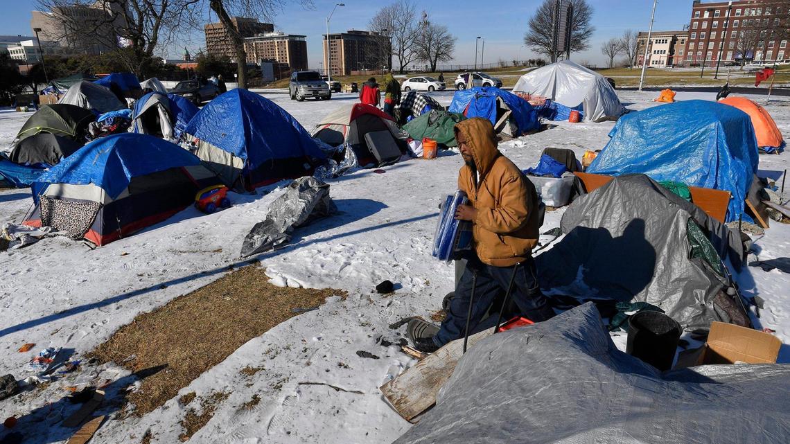 Winter temperatures have plummeted in the last week, leaving the homeless in a more perilous situation to survive. On Monday afternoon at a well established camp on the northeast side of downtown, Walter Jenkins, a resident at the camp, went from tent to tent handing out donated plastic taps for those needing to keep their bedding dry.