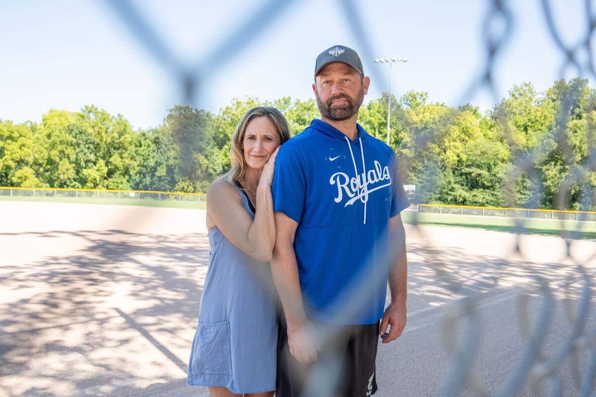 Matt and Tiffany Whitney stand in the batter's warmup circle on a field at Blue Valley Recreation Complex, on Tuesday, Aug. 26, 2025, in Overland Park. Their son, Ryan, whom they lost to suicide, was an avid baseball player. The Whitneys will be hosting a wiffle ball tournament in his honor, with the proceeds going towards Fight Club, a confidential, peer-oriented support group for teenagers dealing with mental health issues.