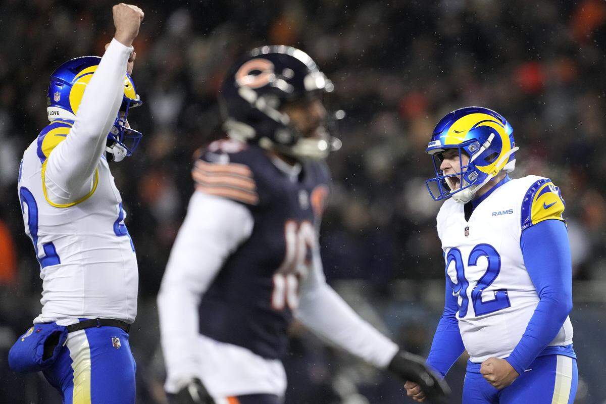 Harrison Mevis #92 of the Los Angeles Rams celebrates with Ethan Evans #42 after kicking the game-winning field goal against the Chicago Bears during overtime in the NFC Divisional Playoffs at Soldier Field on January 18, 2026 in Chicago.