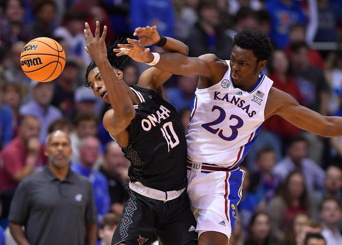 KU’s Ernest Udeh, right tries to pick off an inbounds pass intended for Omaha’s Marquel Sutton during the first half of Monday night’s game at Allen Fieldhouse.