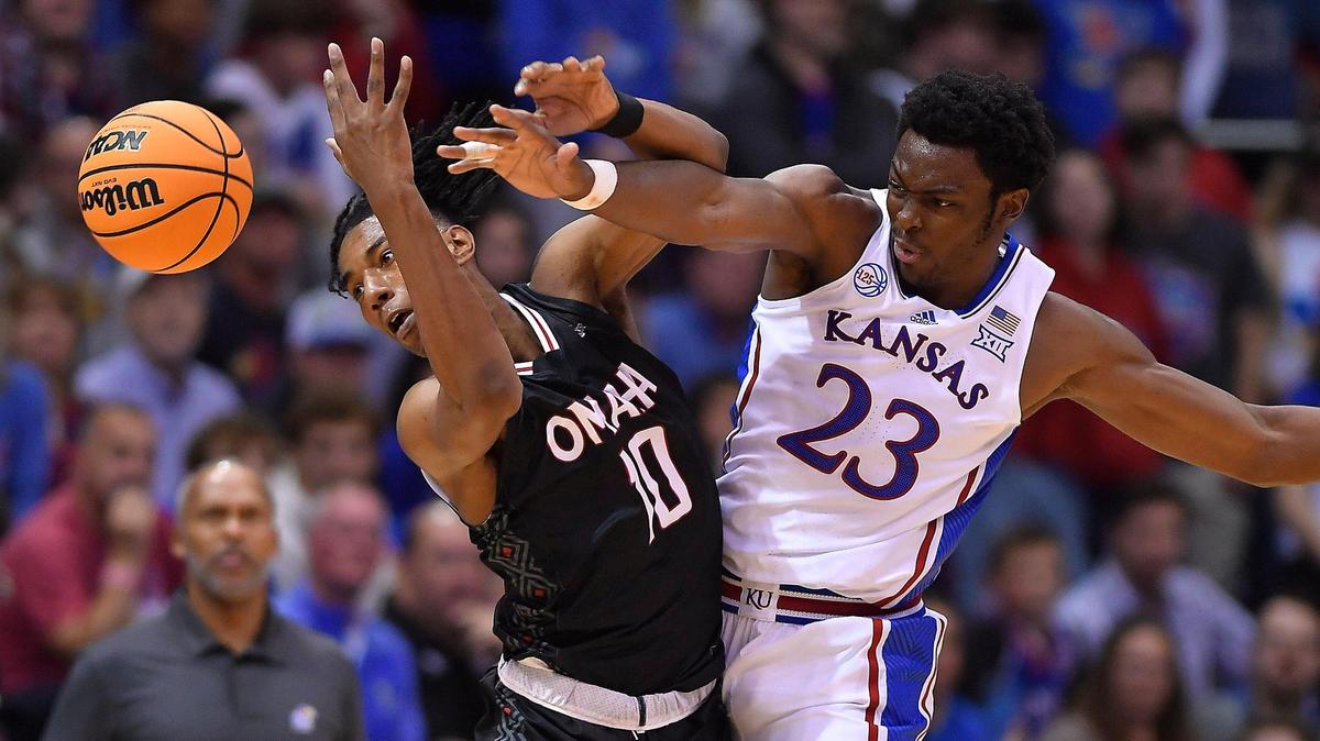 KU’s Ernest Udeh, right tries to pick off an inbounds pass intended for Omaha’s Marquel Sutton during the first half of Monday night’s game at Allen Fieldhouse.