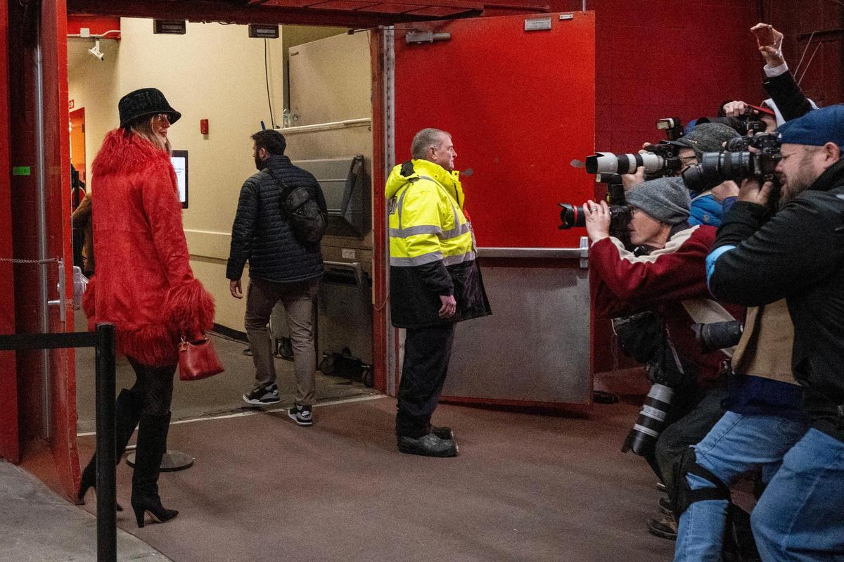 Pop star Taylor Swift is escorted by security to attend an NFL game between the Kansas City Chiefs and Houston Texans as a crowd of photographers eagerly await her arrival on Saturday, Dec. 21, 2024, at GEHA Field at Arrowhead Stadium.