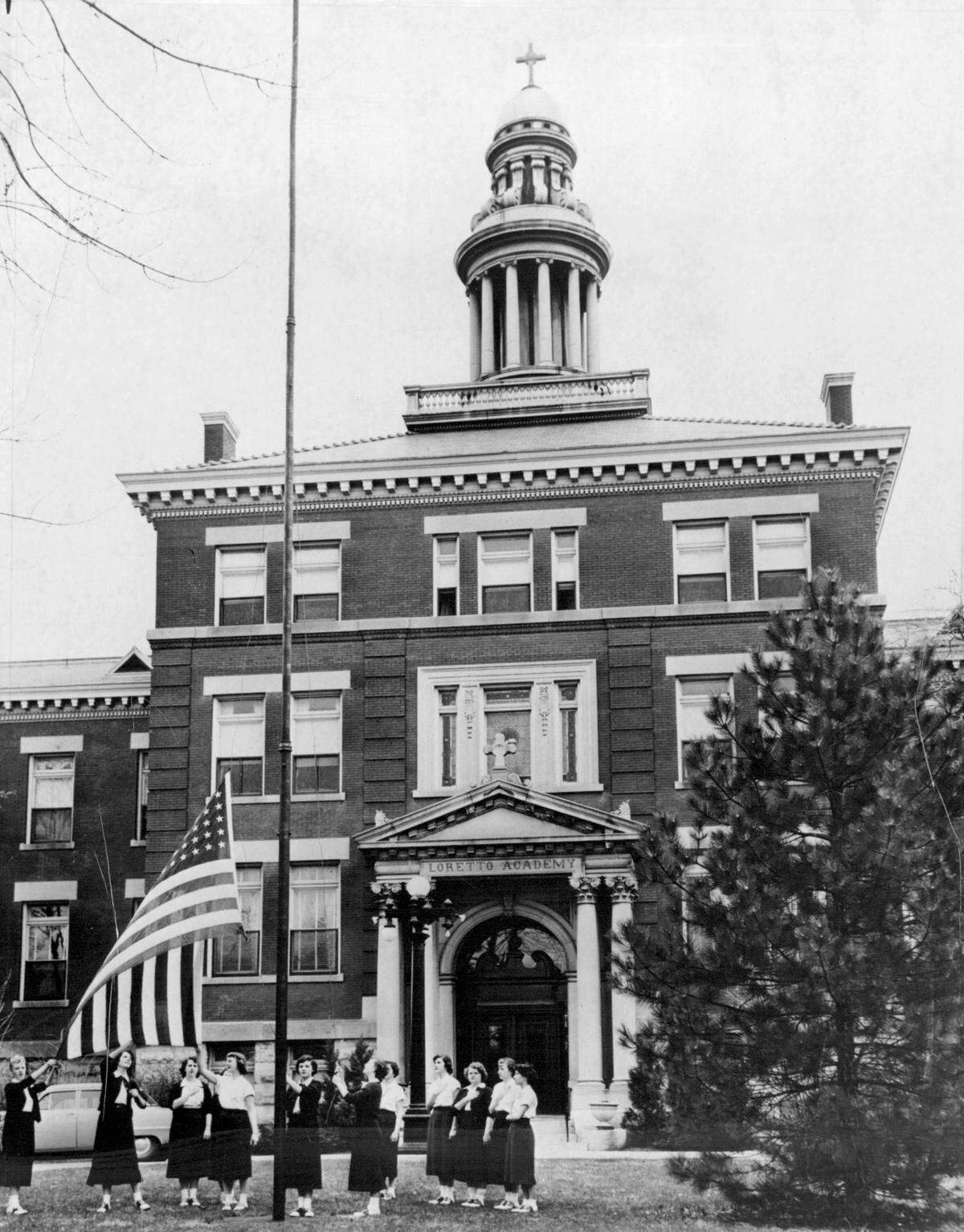 Loretto Academy students raise the flag in 1959.