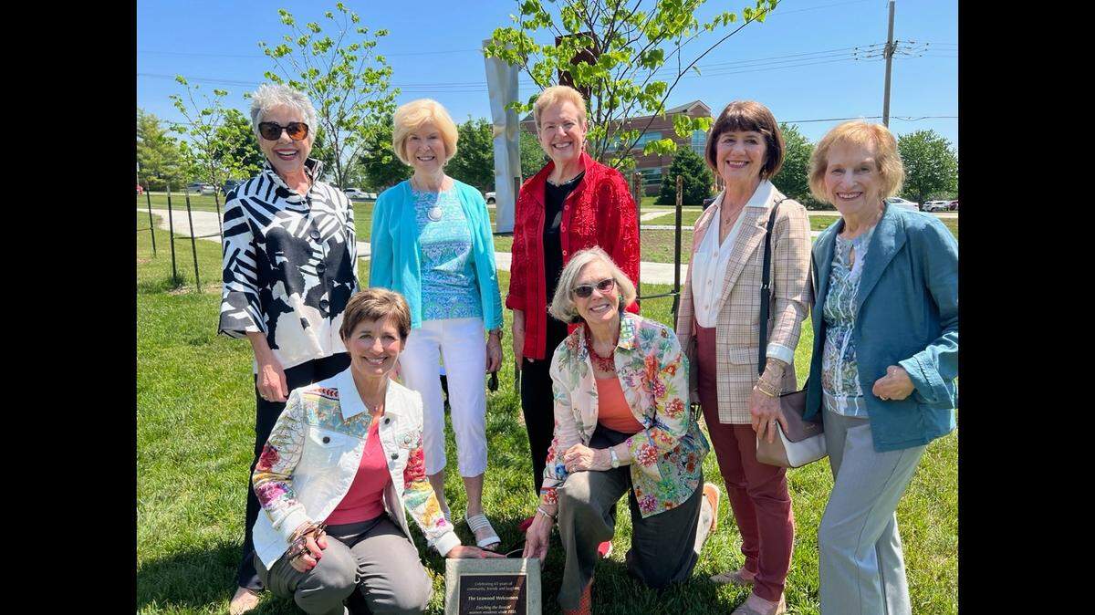 Board members of the Leawood Welcomers, alongside outgoing Leawood mayor Peggy Dunn (bottom left), dedicate a tree and plaque to the city of Leawood in honor of its 75th anniversary.