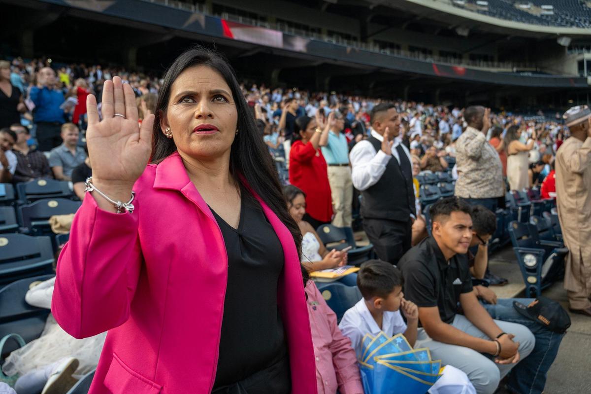Zulma Salas from Monet, Missouri, takes her Oath of Citizenghip Thursday at Kauffman Stadium. She is a native of Durango, Mexico.
