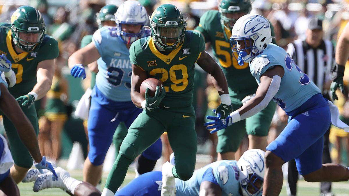 Baylor Bears running back Richard Reese runs through the Kansas Jayhawks’ defense during Saturday’s game in Waco, Texas. Reese leads a solid backfield that TCU will have to slowdown.