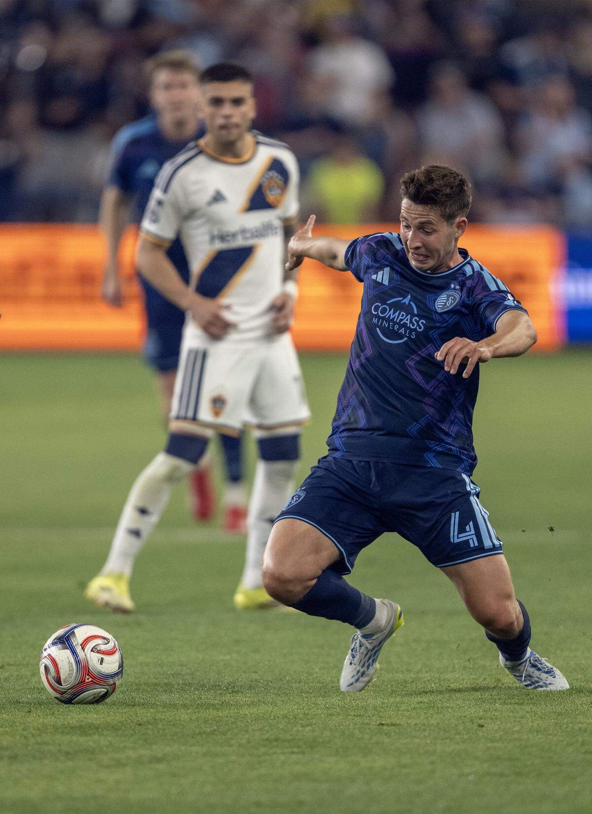 Sporting Kansas City midfielder Lasse Berg Johnsen (4) drives the ball against the LA Galaxy in the second half at Sporting Park on Wednesday, May 13, 2026, 2026, in Kansas City, Kansas. Sporting KC defeated the LA Galaxy, 3-1.