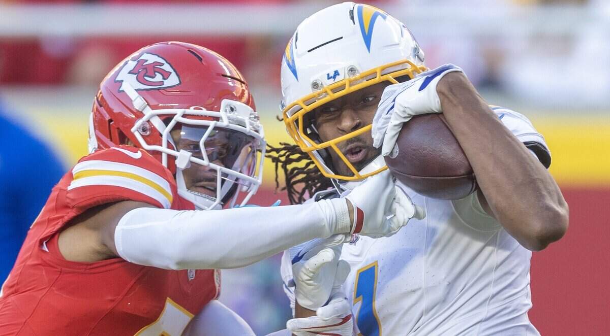 Los Angeles Chargers wide receiver Quentin Johnston (1) haul in a long pass against Kansas City Chiefs cornerback Mansoor Delane (5) during the second half on Sunday at Arrowhead Stadium.