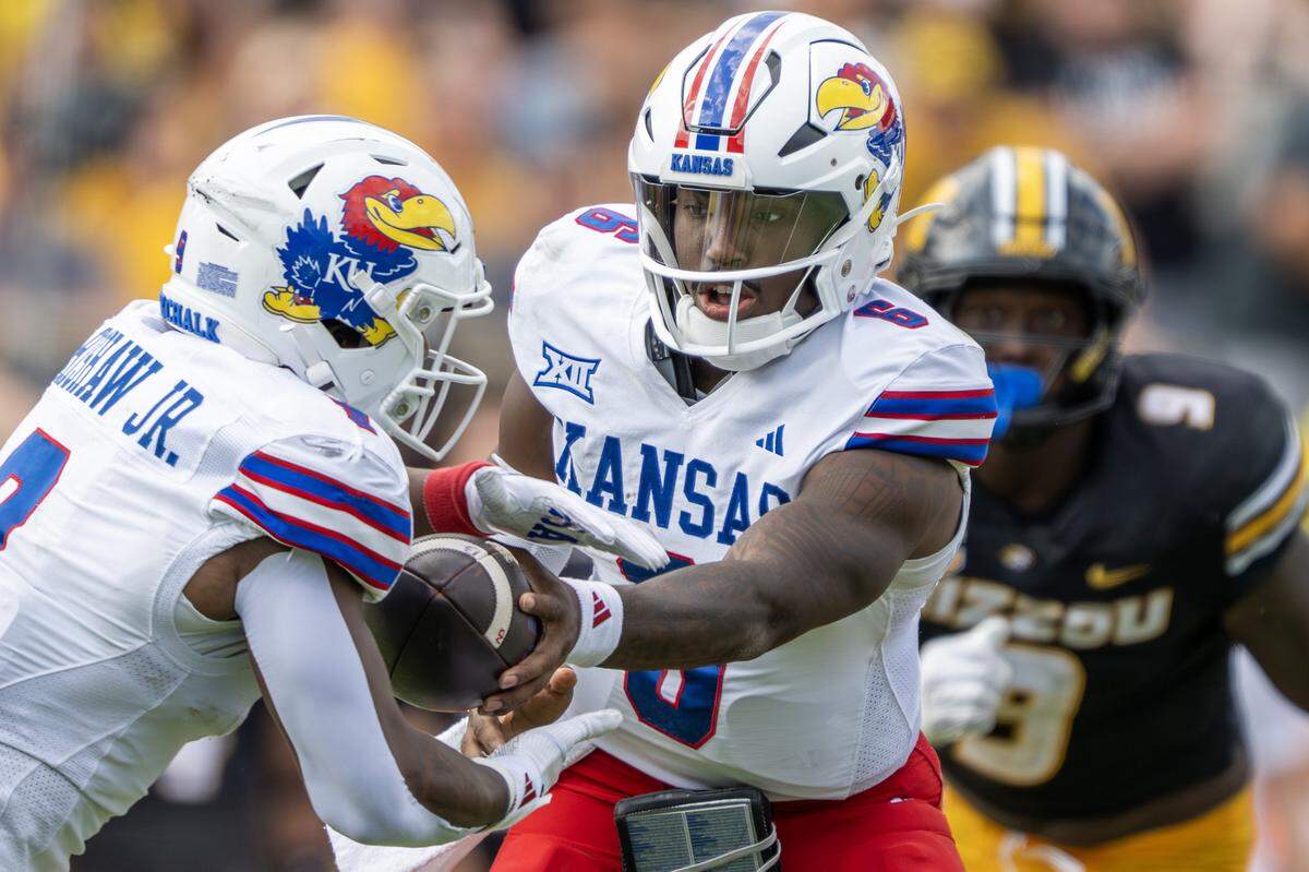 Kansas Jayhawks quarterback Jalon Daniels (6) hands the ball to running back Daniel Hishaw Jr. in the second quarter during a game against the Missouri Tigers at Faurot Field at Memorial Stadium on Saturday, Sept. 6, 2025, in Columbia.