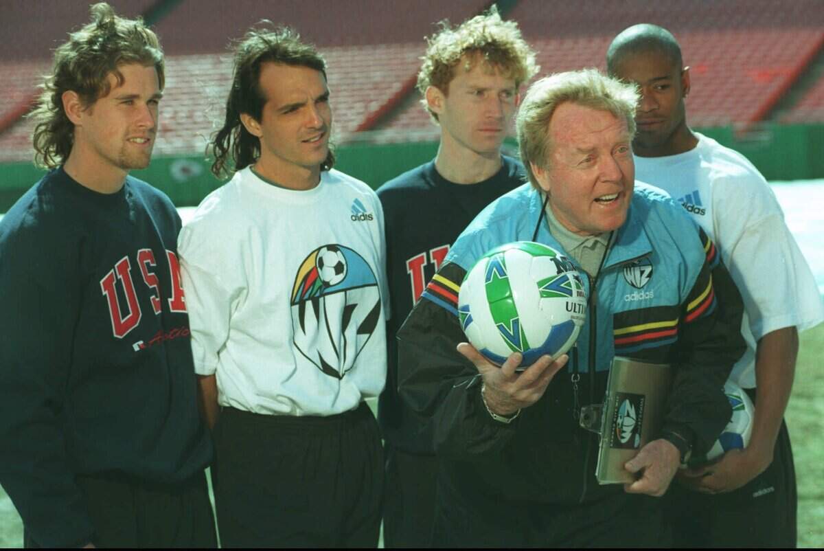 Wiz coach Ron Newman (holding ball) believed the MLS had the right tools to make a top-division soccer league work in America. By his side during a commercial shoot at Arrowhead were players (from left) Scott Uderitz, Eric Eichmann, Tommy Reasoner and Paul Wright.