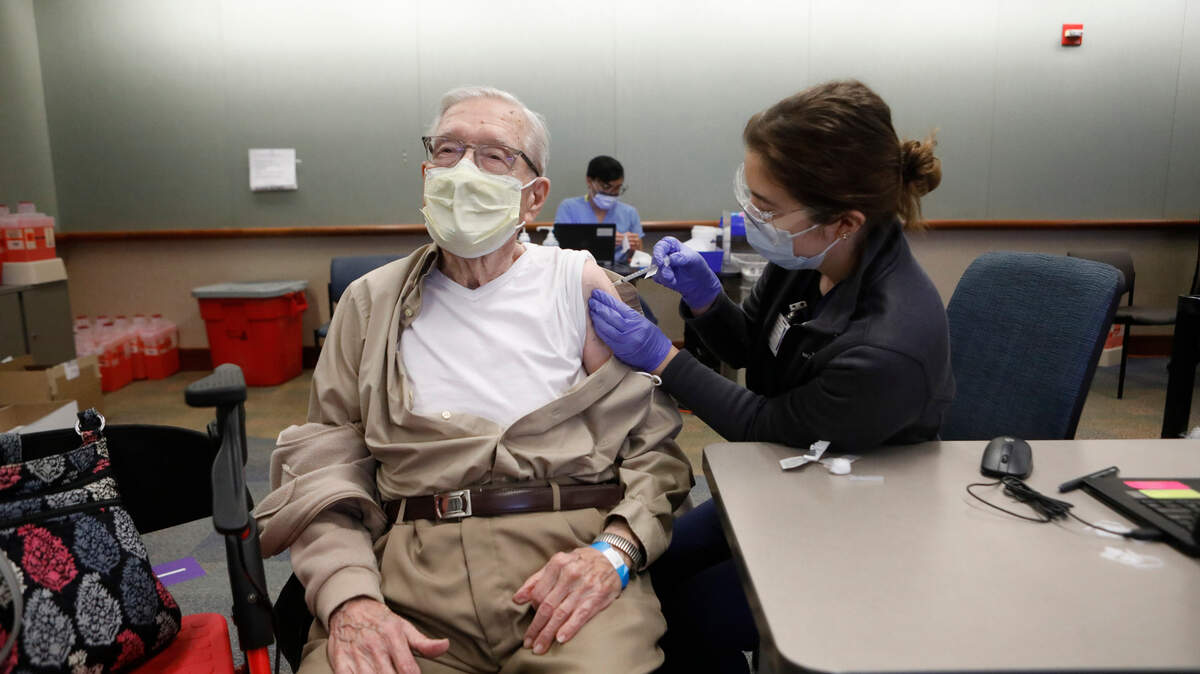 Joseph Riordan receives a COVID-19 vaccination from registered nurse Corinne Felix. File photo.