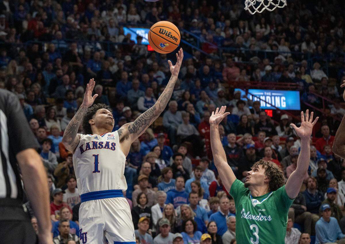 Kansas Jayhawks guard Jayden Dawson (1) goes for a shot as Texas A&M-CC Islanders guard Mason Gibson (3) guards in the second at Allen Fieldhouse on Tuesday, November 11, 2025, in Lawrence.
