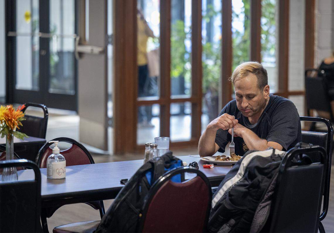 Unhoused since April, Thomas West, 52, enjoys a free hot meal at Center of Grace, an outreach center, on Wednesday, Sept. 24, 2025, in Olathe. He says community resources like this make daily life a little bit easier.