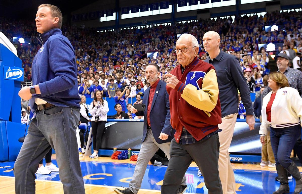 Former KU coach Larry Brown walks onto the Allen Fieldhouse floor during halftime ceremonies honoring players and coaches celebrating KU’s 125 years in college basketball on Jan. 14, 2023.