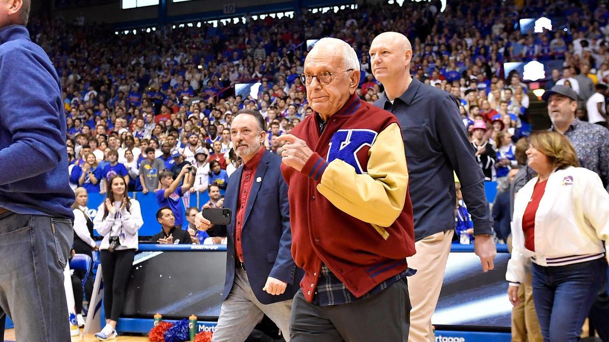 Former KU coach Larry Brown walks onto the Allen Fieldhouse floor during halftime ceremonies honoring players and coaches celebrating KU’s 125 years in college basketball on Jan. 14, 2023.