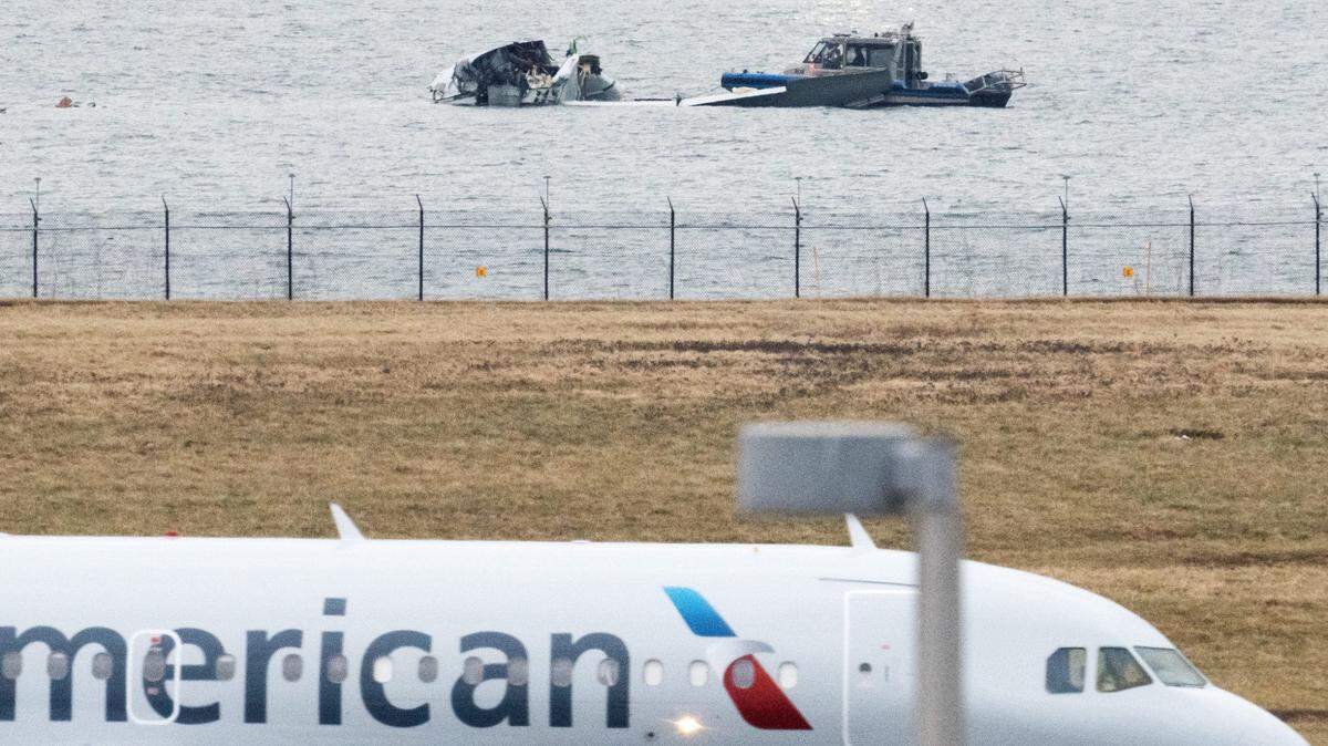 The wreckage of the American Airlines passenger jet is visible as flights land at Ronald Reagan Washington National Airport on Friday, Jan. 31, days after it collided with an Army Black Hawk helicopter, resulting in the deaths of 67 people.