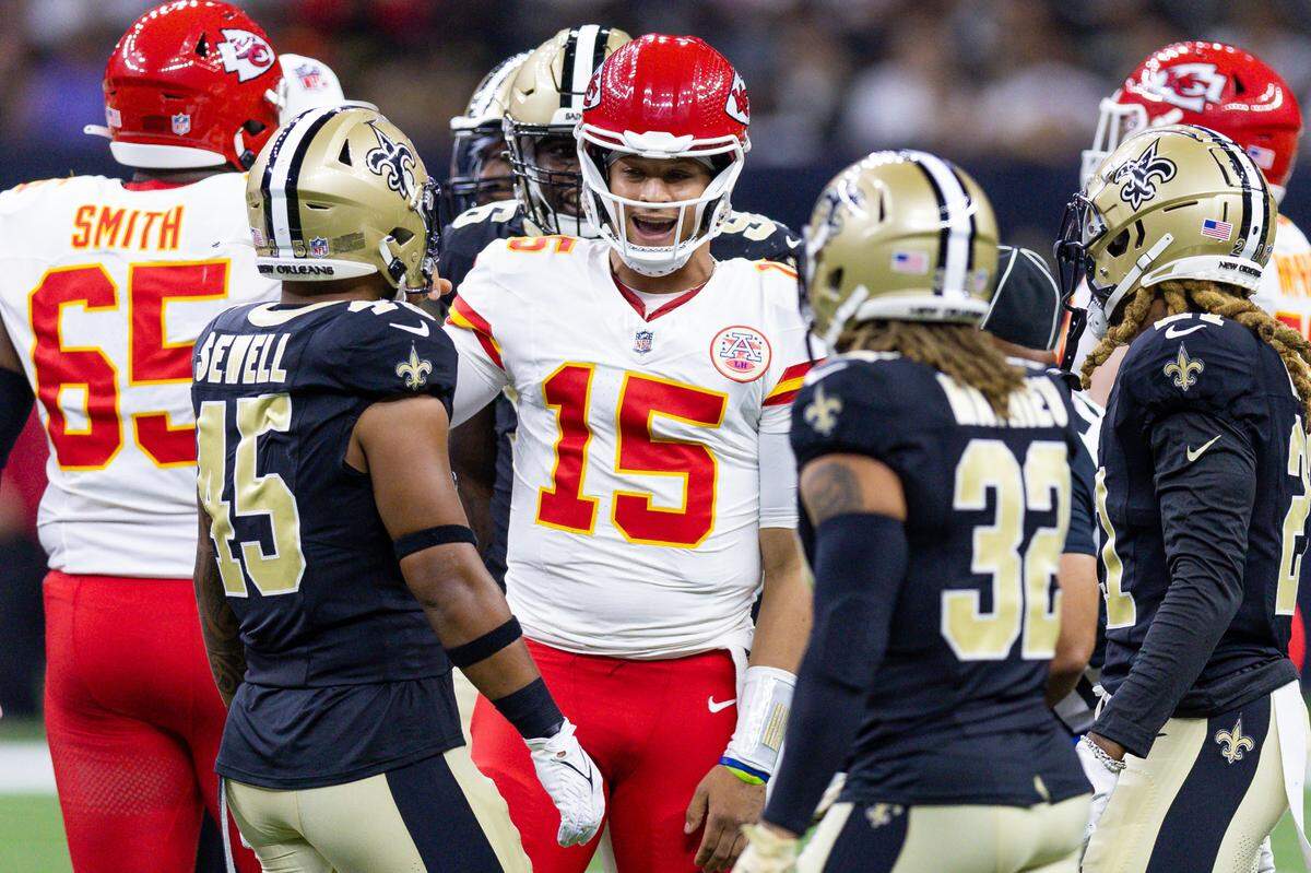 Kansas City Chiefs quarterback Patrick Mahomes (15) talks to New Orleans Saints linebacker Nephi Sewell (45) and safety Tyrann Mathieu (32) after being tackled during the first half at the Caesars Superdome on Aug. 13, 2023.