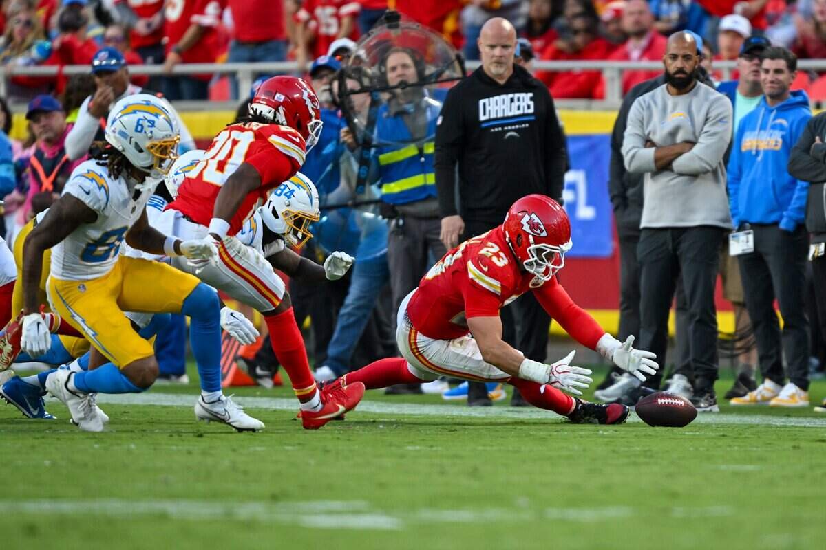Kansas City Chiefs linebacker Drue Tranquill (23) picks up the fumbled ball in the second half of the Kansas City Chiefs vs. Los Angeles Chargers NFL regular season game at Arrowhead Stadium in Kansas City on Oct. 18, 2026.