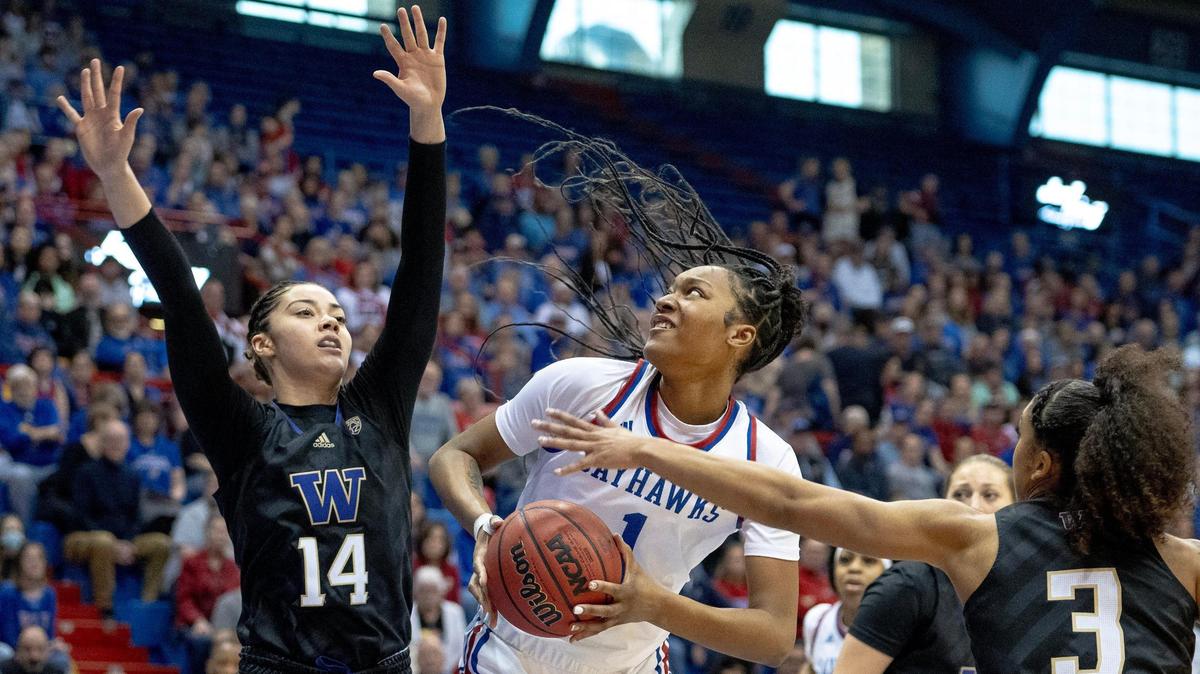 Kansas center Taiyanna Jackson (1) goes up against Washington forward Dalayah Daniels (14) during a WNIT semifinal game, Wednesday, March 29, 2023, in Lawrence.