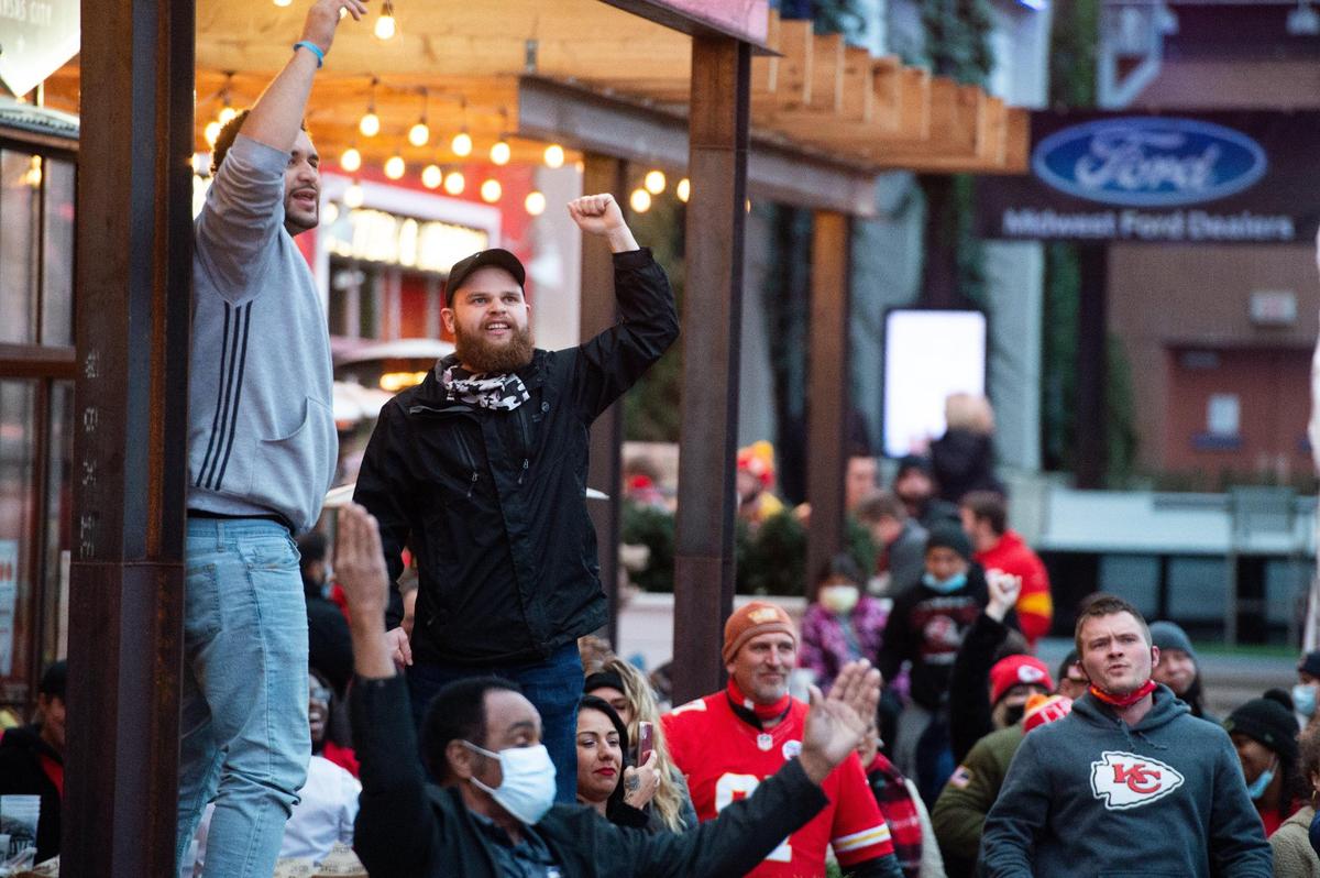 Chiefs fans celebrate after backup quarterback Chad Henne completed a 5-yard pass to Tyreek Hill to get the first down that allowed the Chiefs to run out the clock Sunday, Jan. 17, 2021.