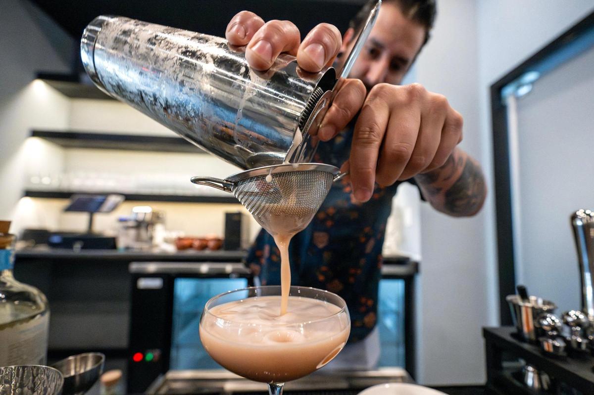 Manny Gomez, beverage consultant, prepares a Cherry Eclipse cocktail at Kohinoor, a cocktail bar and lounge, on Tuesday, April 8, in Kansas City. The cocktail features blanco tequila, lemon juice, cherry liqueur, mint, coriander simple syrup and cherry bitters.